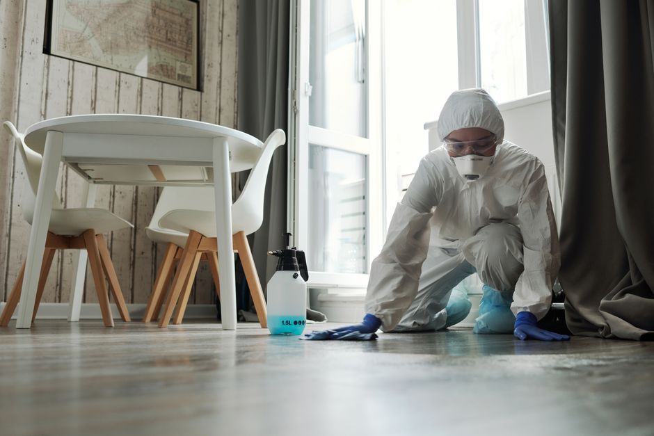 Photo by Matilda Wormwood on Pexels Specialized cleaning person in protective suit disinfecting a floor indoors for hygiene and safety. - Photo by Matilda Wormwood on Pexels