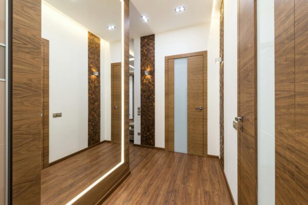 Sleek and contemporary hallway interior with wooden elements and warm lighting.