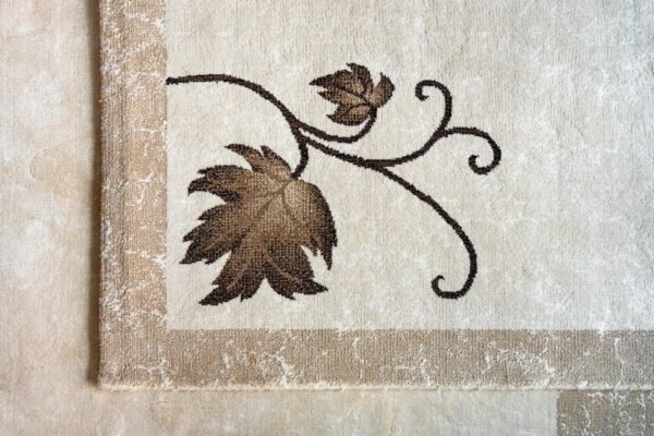 Close-up of an elegant floral pattern on a textured beige rug enhancing interior decor.