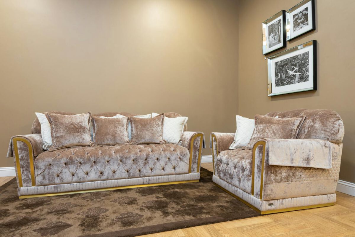 Sophisticated living room with velvet sofas and stylish decor enhancing modern luxury.