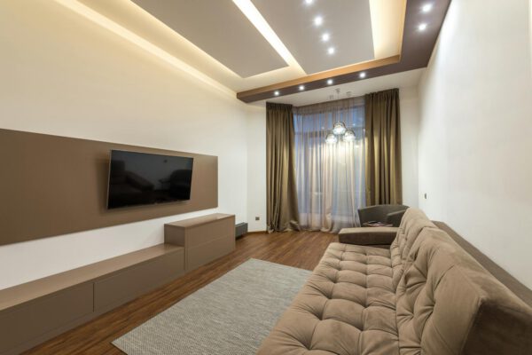 Spacious living room featuring modern design with cozy furniture and warm lighting.