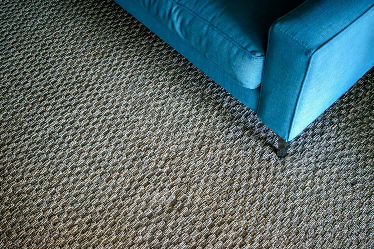 Modern blue sofa on a textured woven carpet