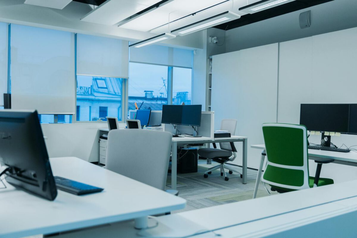 Bright modern office with computer workstations and large windows