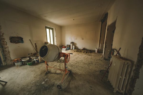 Empty room with a concrete mixer and renovation tools
