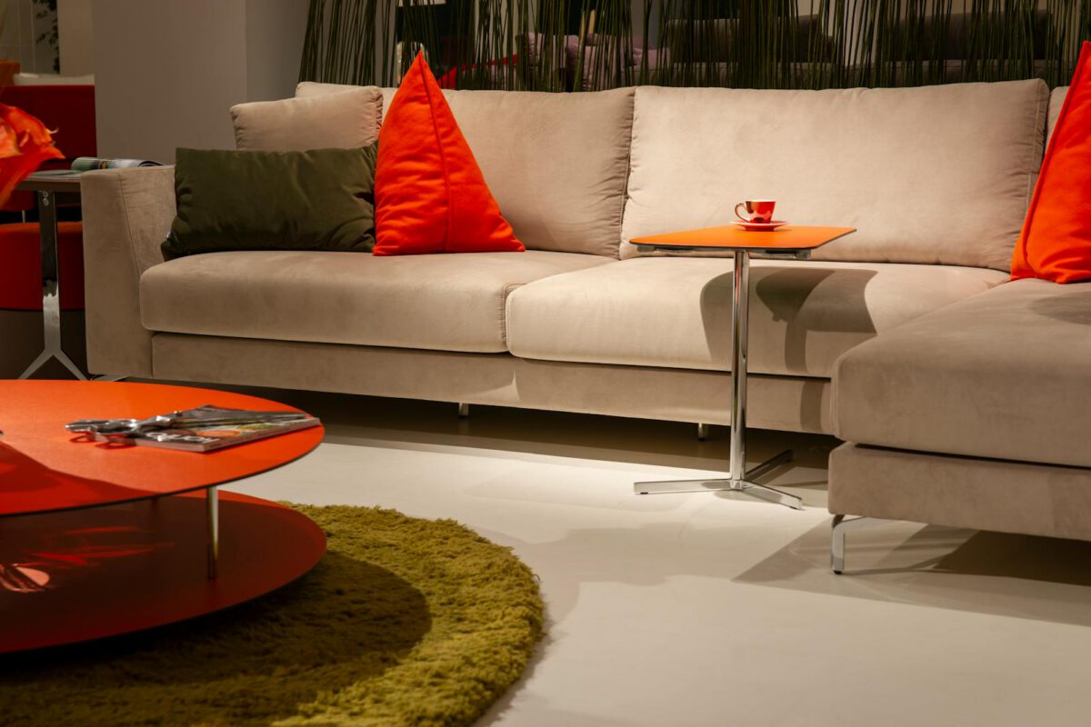 Elegant beige fabric sofa with cushions in a stylish living room