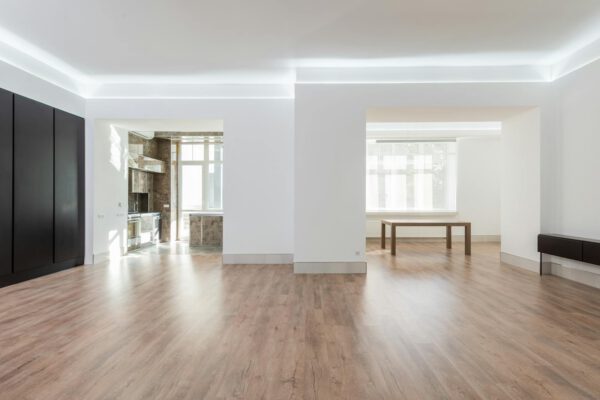 Bright empty apartment with wooden flooring