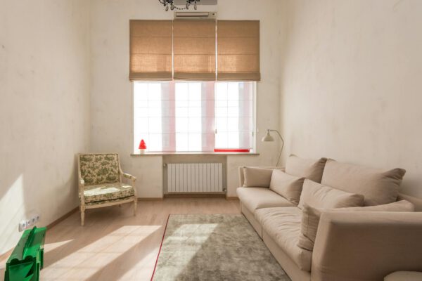 Bright minimalist living room with beige sofa