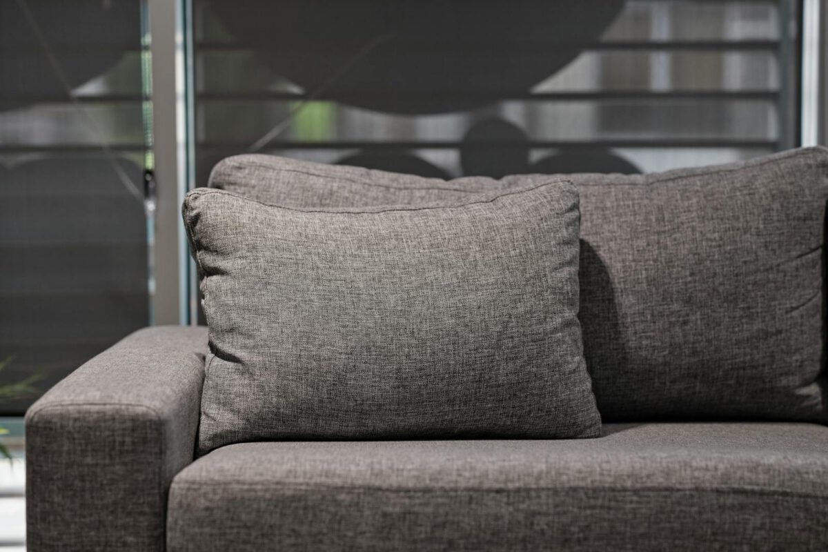 Elegant grey upholstered sofa with plush cushions