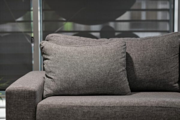 Elegant grey upholstered sofa with plush cushions